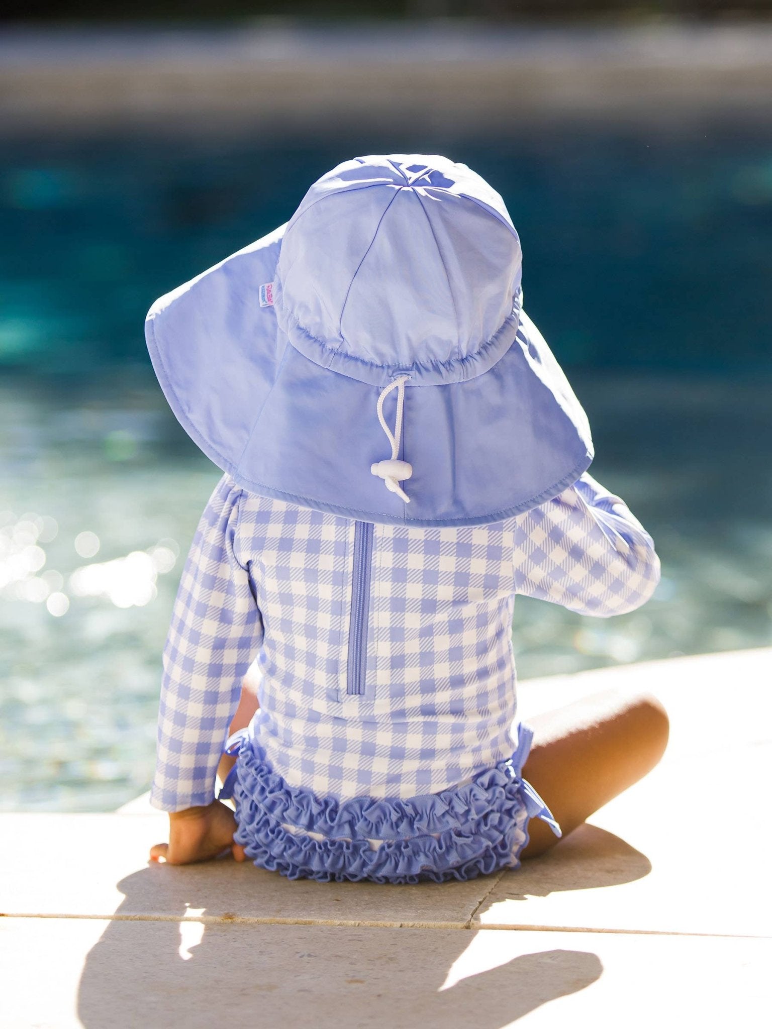 RuffleButts + RuggedButts - Baby Girls Periwinkle Blue Gingham Long Sleeve One Piece Rash Guard Swimsuit with Signature Rear Ruffles - Little Stars Toy Store & PlayhouseRuffleButts + RuggedButts