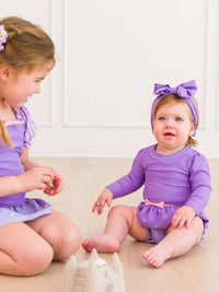 RuffleButts + RuggedButts - Girls Amethyst Princess Long Sleeve Bow Skirted One Piece Swimsuit - Little Stars Toy Store & PlayhouseRuffleButts + RuggedButts
